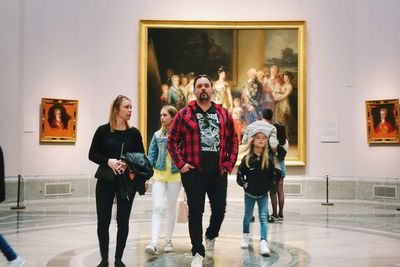 Portrait of young couple standing in corridor