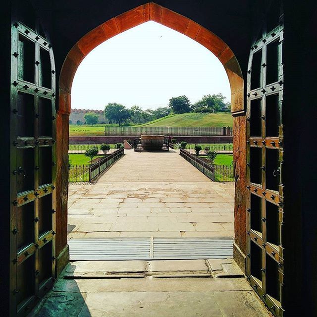 arch, built structure, architecture, railing, archway, the way forward, indoors, gate, arched, day, entrance, building exterior, architectural column, tree, narrow, bridge - man made structure, connection, empty, in a row, no people