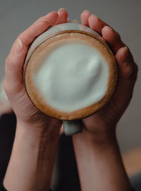 Close-up of hand holding coffee cup