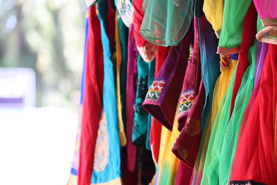 Close-up of multi colored flags hanging at store