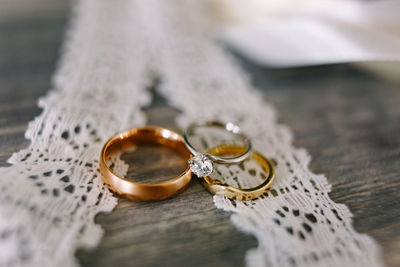 Close-up of wedding rings on table