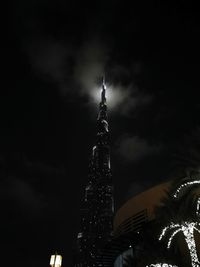 Low angle view of illuminated tower at night