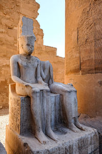 Carved sitting statue of king. luxor.