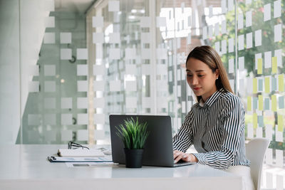 Young woman using laptop on table