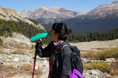 Rear view of man standing on mountain