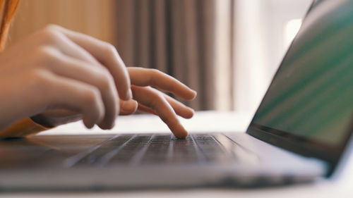 Midsection of woman using laptop