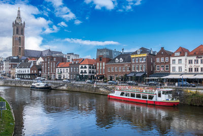 Boats in river against sky