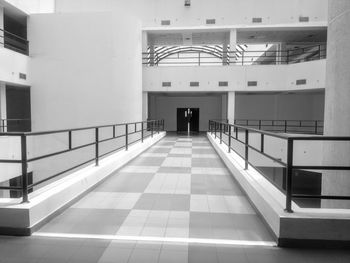 Rear view of man walking on escalator