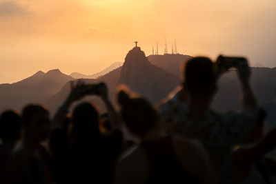 Tourists enjoy the view from the sugarloaf mountain towards the christ the redeemer statue of rio