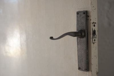 Close-up of door handle on wall