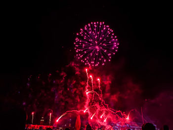 Low angle view of firework display at night