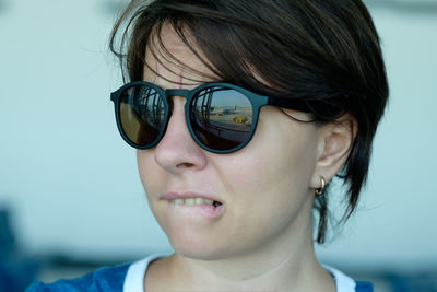 Close-up portrait of young woman wearing sunglasses