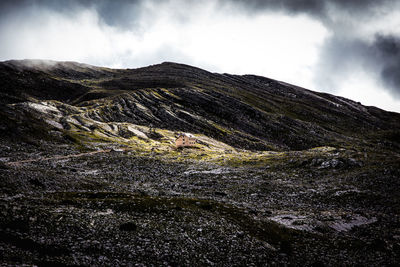 Scenic view of mountains against cloudy sky