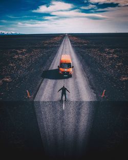 Rear view of person standing on road against sky