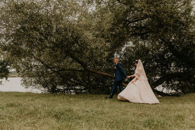 Rear view of woman standing on field