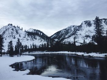 Scenic view of frozen river against sky during winter