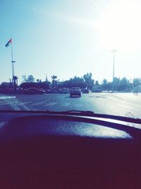 Cars on street against sky