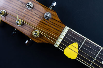 High angle view of guitar against black background