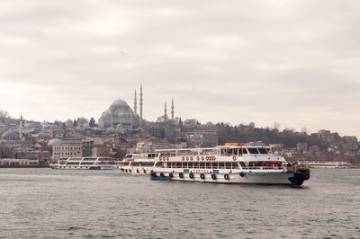 View of boats in river against buildings