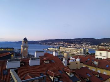 High angle view of townscape by sea against sky