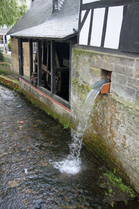 Water flowing over stream against wall