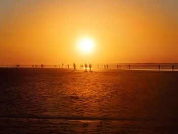 Scenic view of beach against sky during sunset