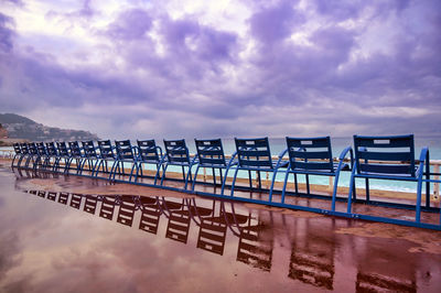 Information sign on beach against sky