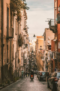 Street amidst buildings in city against sky