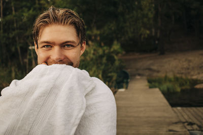 Portrait of smiling man wrapped in towel