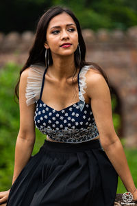 Portrait of a beautiful young woman standing outdoors