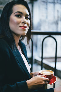 Close-up of woman holding coffee cup