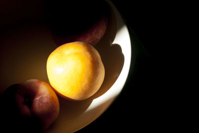 Close-up of apple against black background