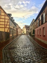 Empty alley amidst houses in town