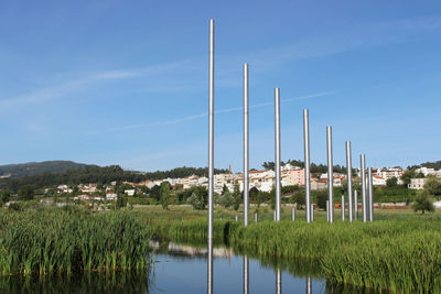 View of poles on field against blue sky