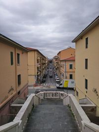 Street amidst buildings in town against sky