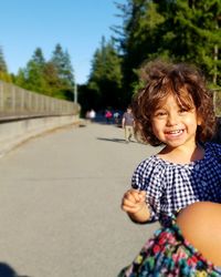 Portrait of smiling girl on road