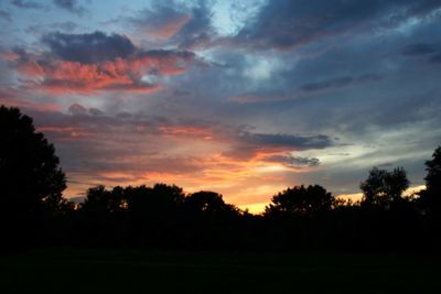 Silhouette trees against sky during sunset