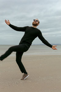 Full length of person on beach against sky