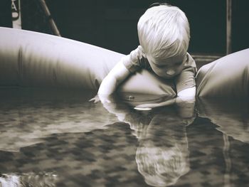 Cute boy playing in wading pool