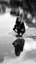 Portrait of young woman sitting in lake