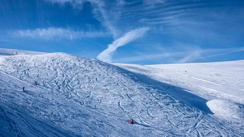 Scenic view of snowcapped mountain against blue sky