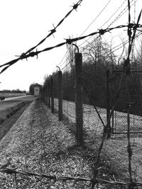 Fence on field against sky
