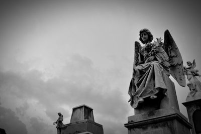 Low angle view of statue against cloudy sky