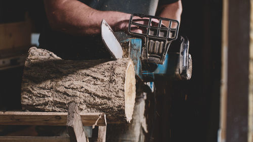 Close-up of man working on wood