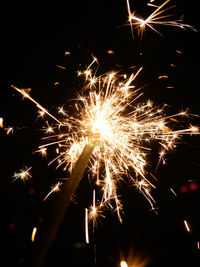 Low angle view of firework display at night