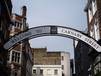Low angle view of road sign against clear sky