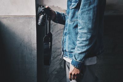 Low section of man holding camera