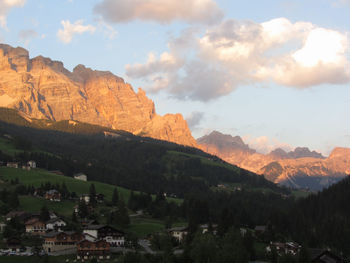 Scenic view of townscape and mountains against sky