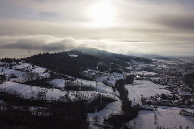 Scenic view of snow covered landscape against sky during sunset