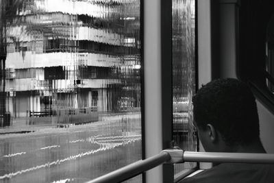 Woman looking through window